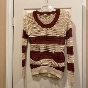 Cable knit burgundy and cream colored sweater with pockets